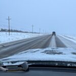 Driver's view of two lane road in winter.